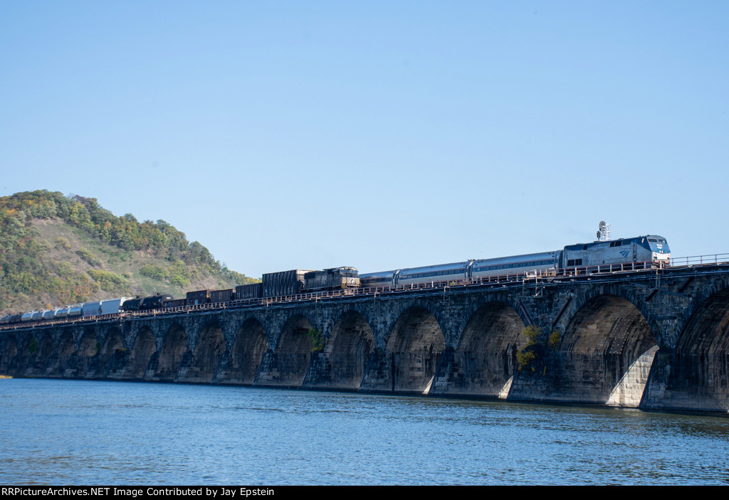 The Pennsylvanian passes a freight on the Rockville Bridge